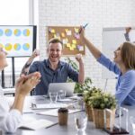 A vibrant team meeting showcasing collaboration and innovation at Ariel Software Solutions, emphasizing employee experience in the workplace.